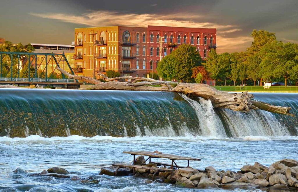 Log balanced on top of a dam in Grand Rapids.